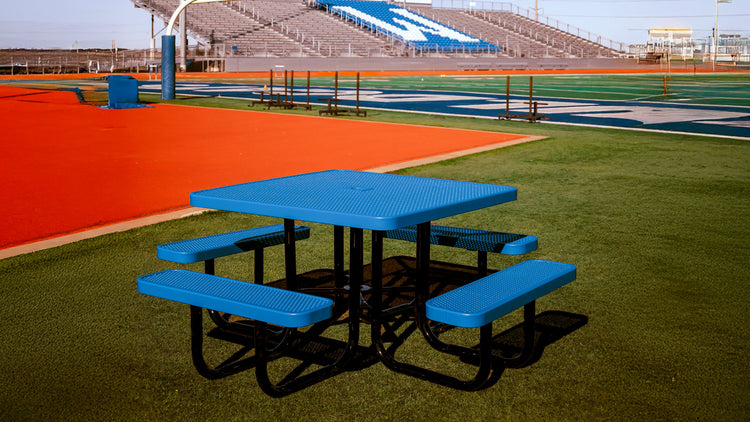 Blue picnic table in a school sports field