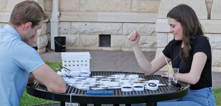 people playing game on table outdoor