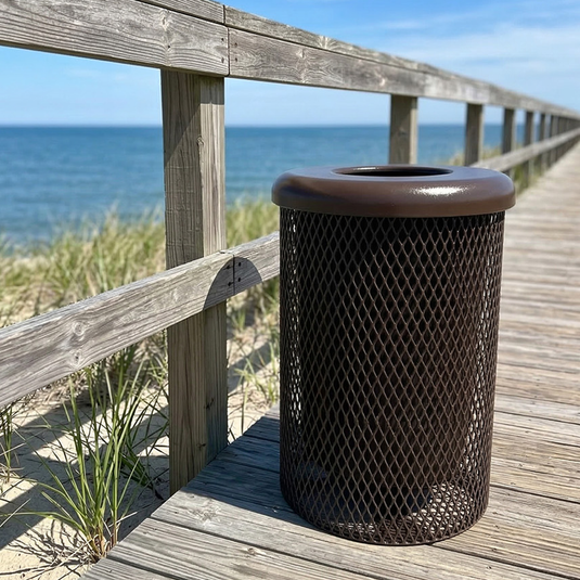 Mesh trash can on a wooden boardwalk by the ocean