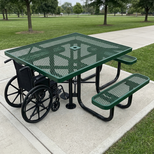 Green metal picnic table with wheelchair accessibility features in a park setting